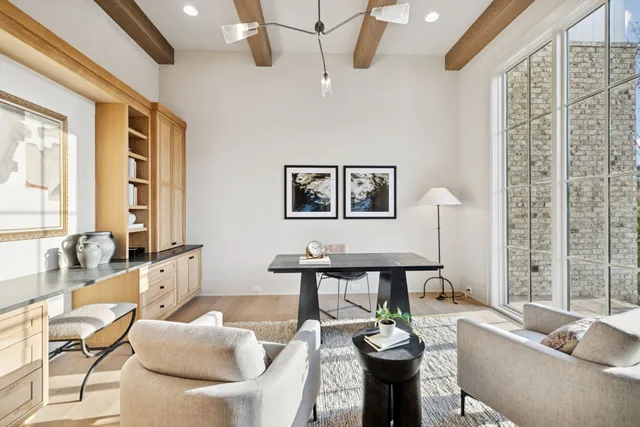 a large kitchen with kitchen island a stove a sink a center island and a wooden floor