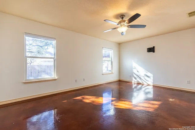 a view of livingroom with window ceiling fan and wooden floor