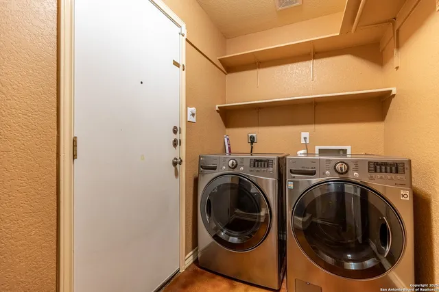 a view of an empty room with a staircase