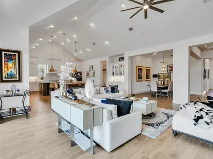 a living room with furniture and a view of kitchen