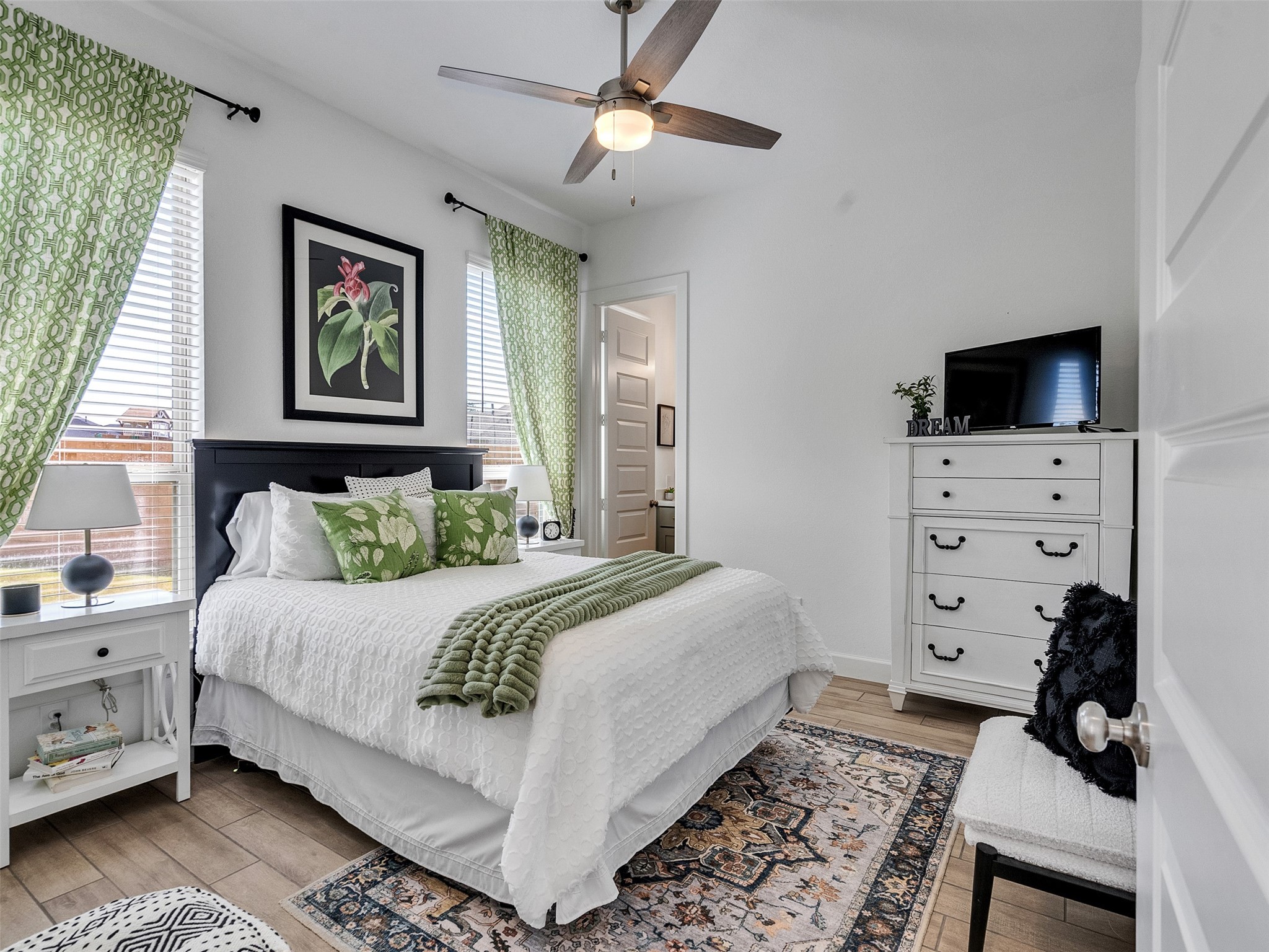 5422 Farm Hill Way Fulshear, TX 77406 - Photo 36 of 50 a bedroom with a bed a dresser and a chandelier