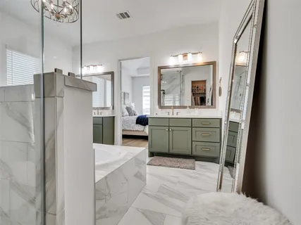 a bathroom with a tub sink and mirror