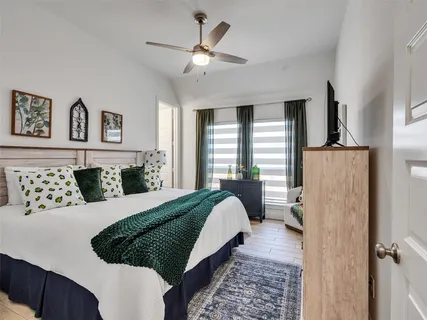 a bedroom with a large bed and a chandelier