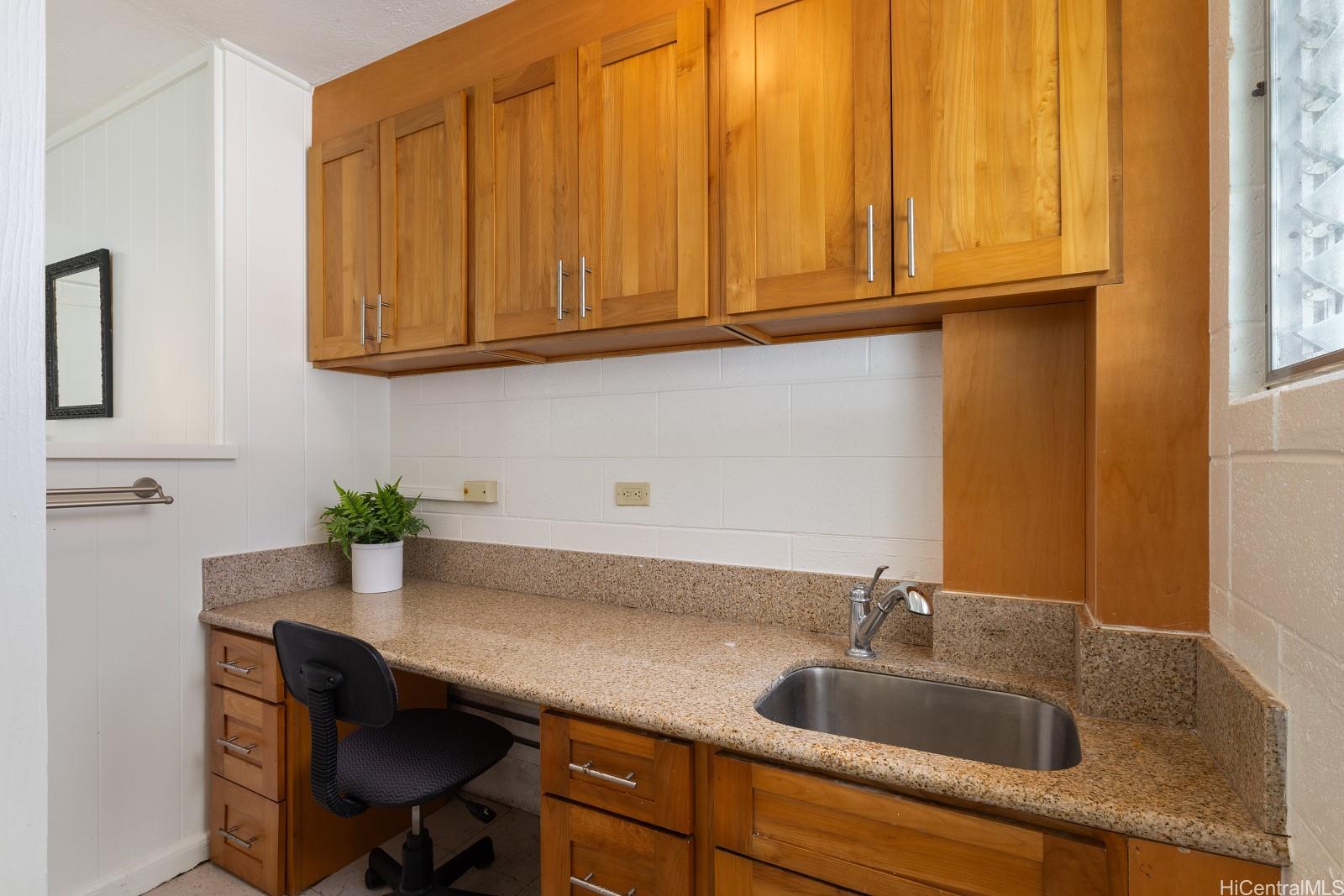 240 Puiwa Road Honolulu, HI 96817 - Photo 15 of 18 a kitchen with a sink cabinets and a window