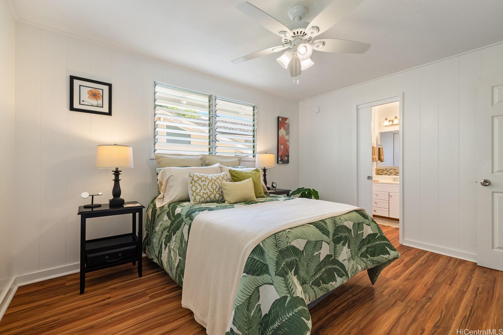 240 Puiwa Road Honolulu, HI 96817 - Photo 6 of 18 a bedroom with a bed and wooden floor