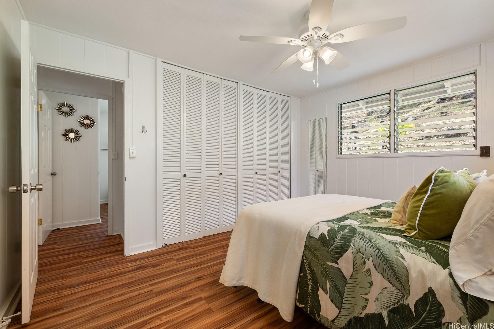240 Puiwa Road Honolulu, HI 96817 - Photo 7 of 18 a bedroom with a bed and wooden floor