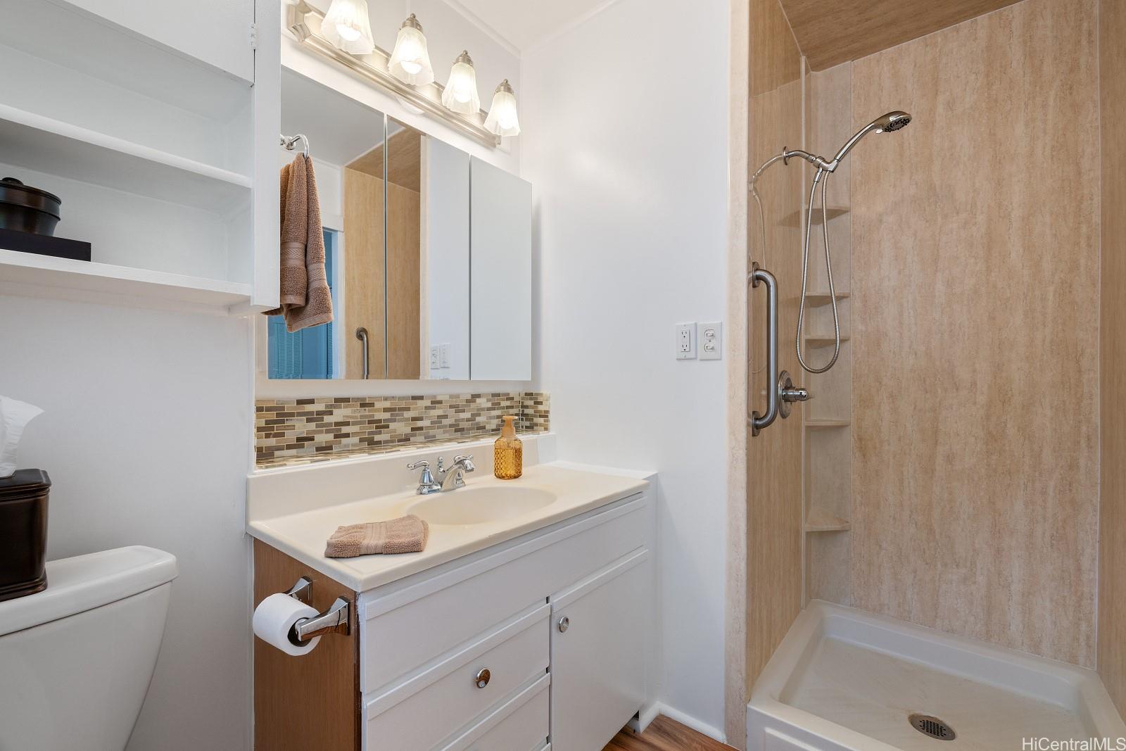 240 Puiwa Road Honolulu, HI 96817 - Photo 8 of 18 a bathroom with a sink a vanity a mirror and shower