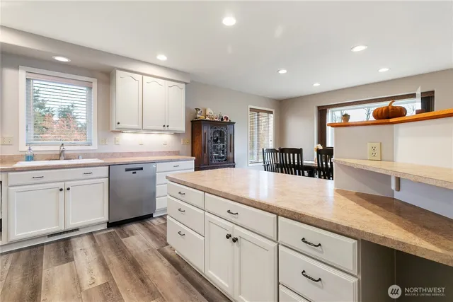 a kitchen with cabinets a sink and appliances