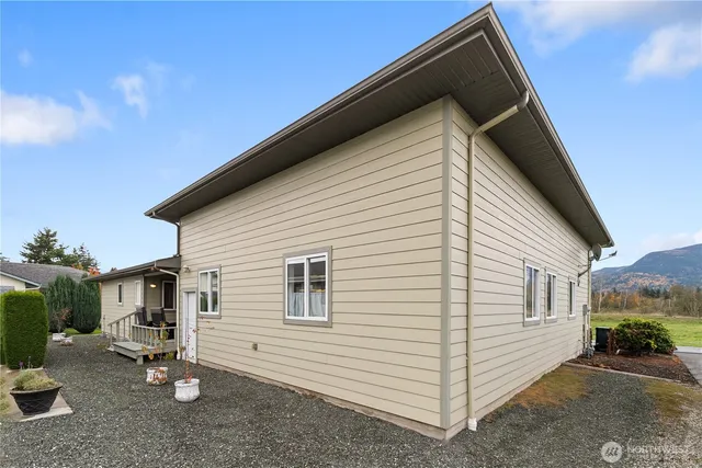 a view of a small house with backyard