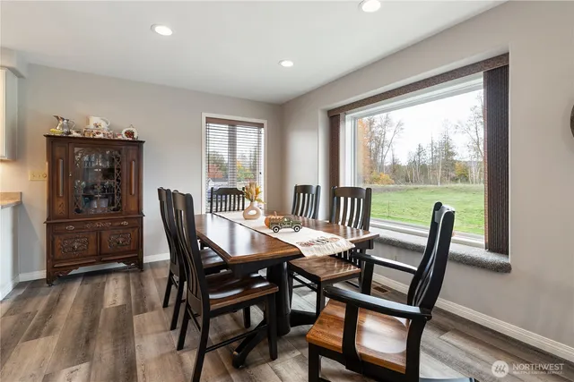 a view of a dining room with furniture window and wooden floor