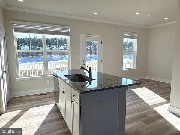 a kitchen with granite countertop a sink and cabinets