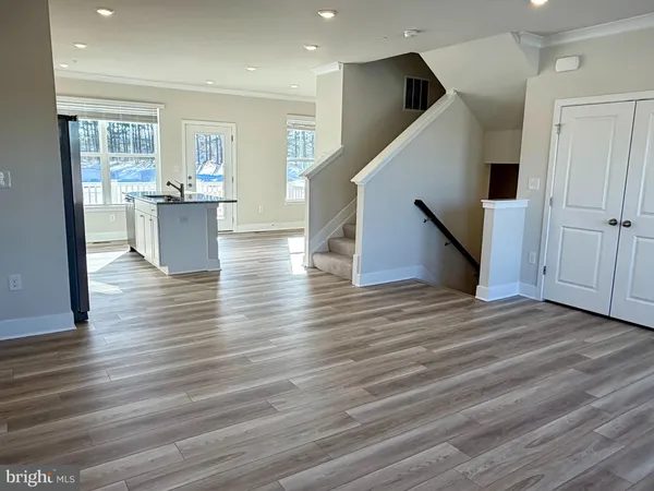 a view of a kitchen with furniture and wooden floor