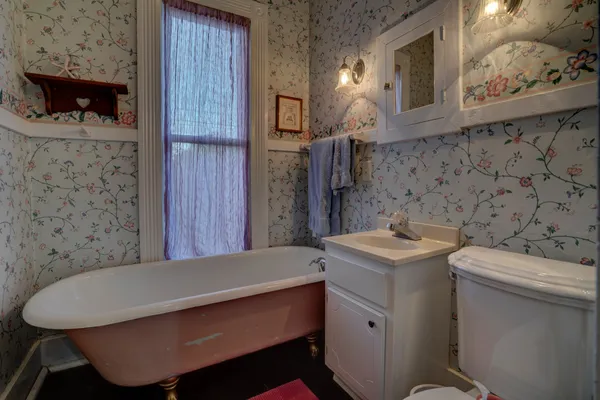 a bathroom with a sink toilet and a mirror