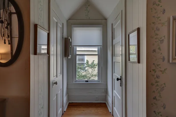 a view of a room with wooden floors and large windows