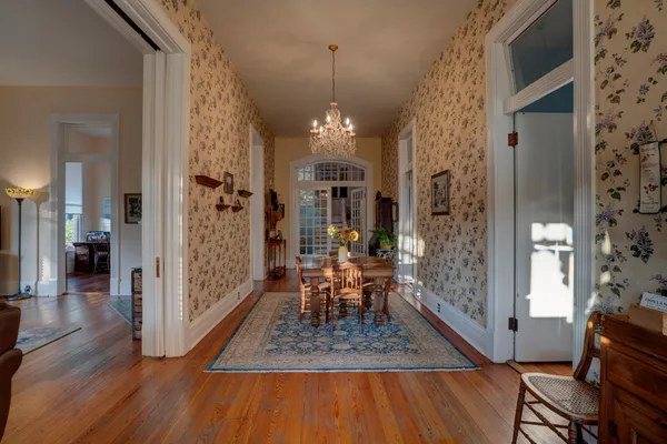 a living room with furniture a bookshelf and a large window