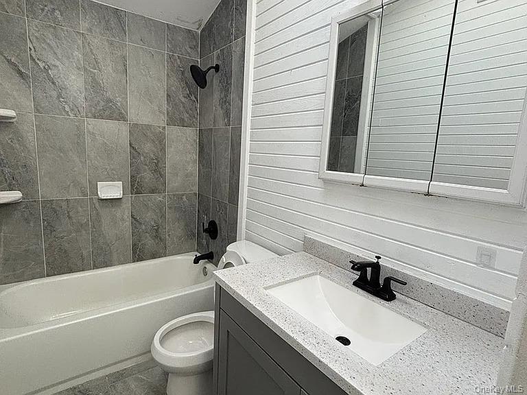 61 Montgomery Avenue Mastic, NY 11950 - Photo 11 of 14 a bathroom with a sink and a toilet