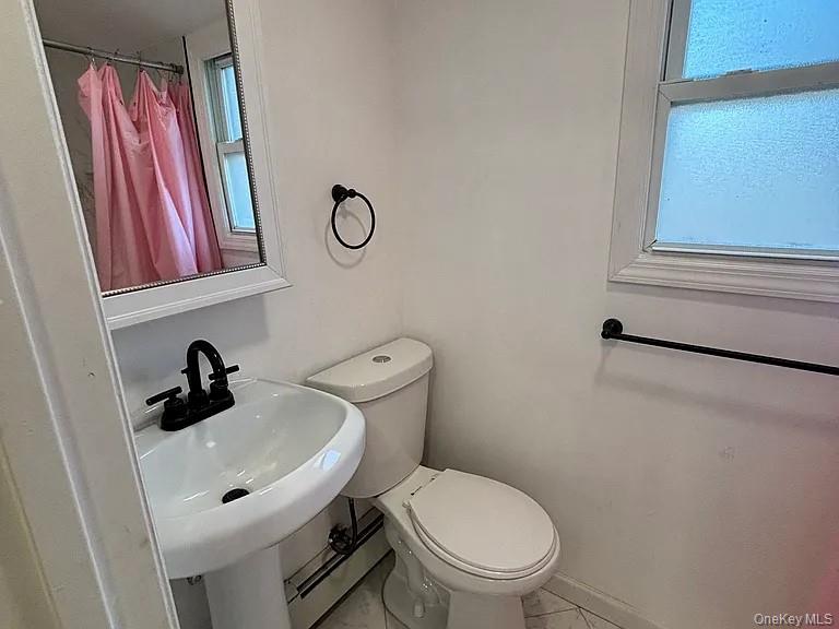 61 Montgomery Avenue Mastic, NY 11950 - Photo 12 of 14 a bathroom with a toilet and a sink