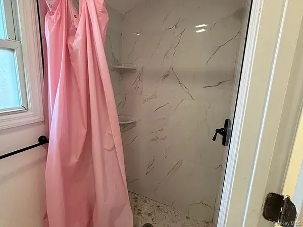 a bathroom with a shower curtain and a sink