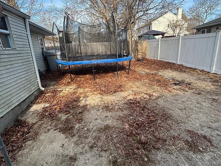 61 Montgomery Avenue Mastic, NY 11950 - Photo 14 of 14 a front view of a house with a yard