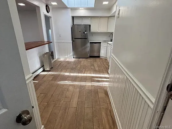 a view of storage and utility room with refrigerator