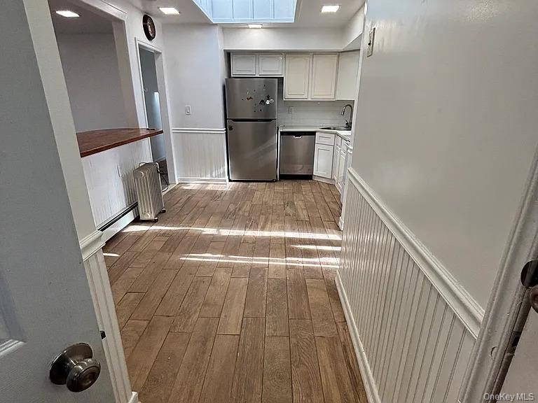 61 Montgomery Avenue Mastic, NY 11950 - Photo 2 of 14 a view of storage and utility room with refrigerator