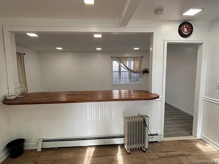 61 Montgomery Avenue Mastic, NY 11950 - Photo 5 of 14 a kitchen with granite countertop a table and chair