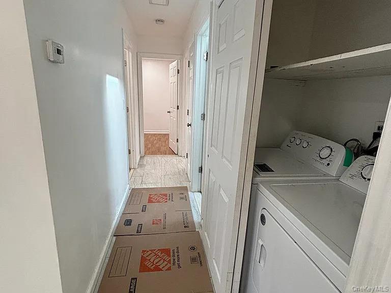 61 Montgomery Avenue Mastic, NY 11950 - Photo 6 of 14 view of hallway with washing machine