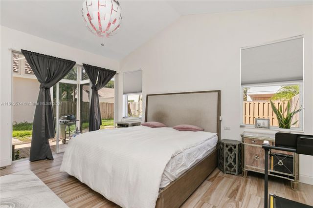 a bedroom with a large bed and a large window