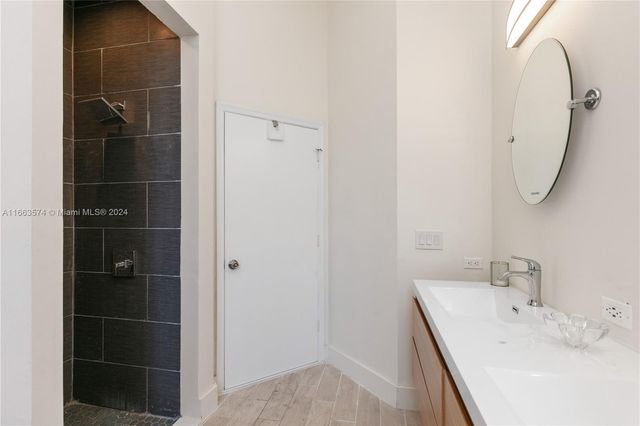 a bedroom with a bed wooden floor and a window