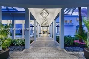 a living room with furniture a fireplace and a chandelier