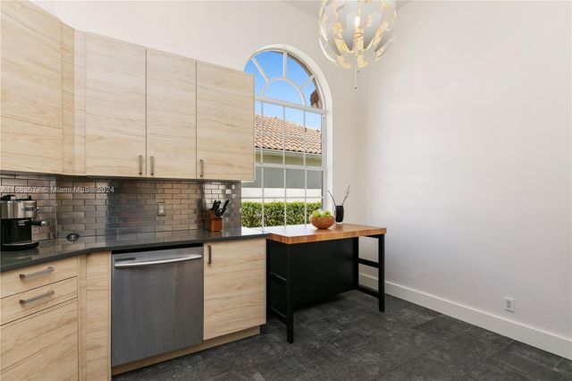 a kitchen with stainless steel appliances a sink dishwasher a stove and white cabinets