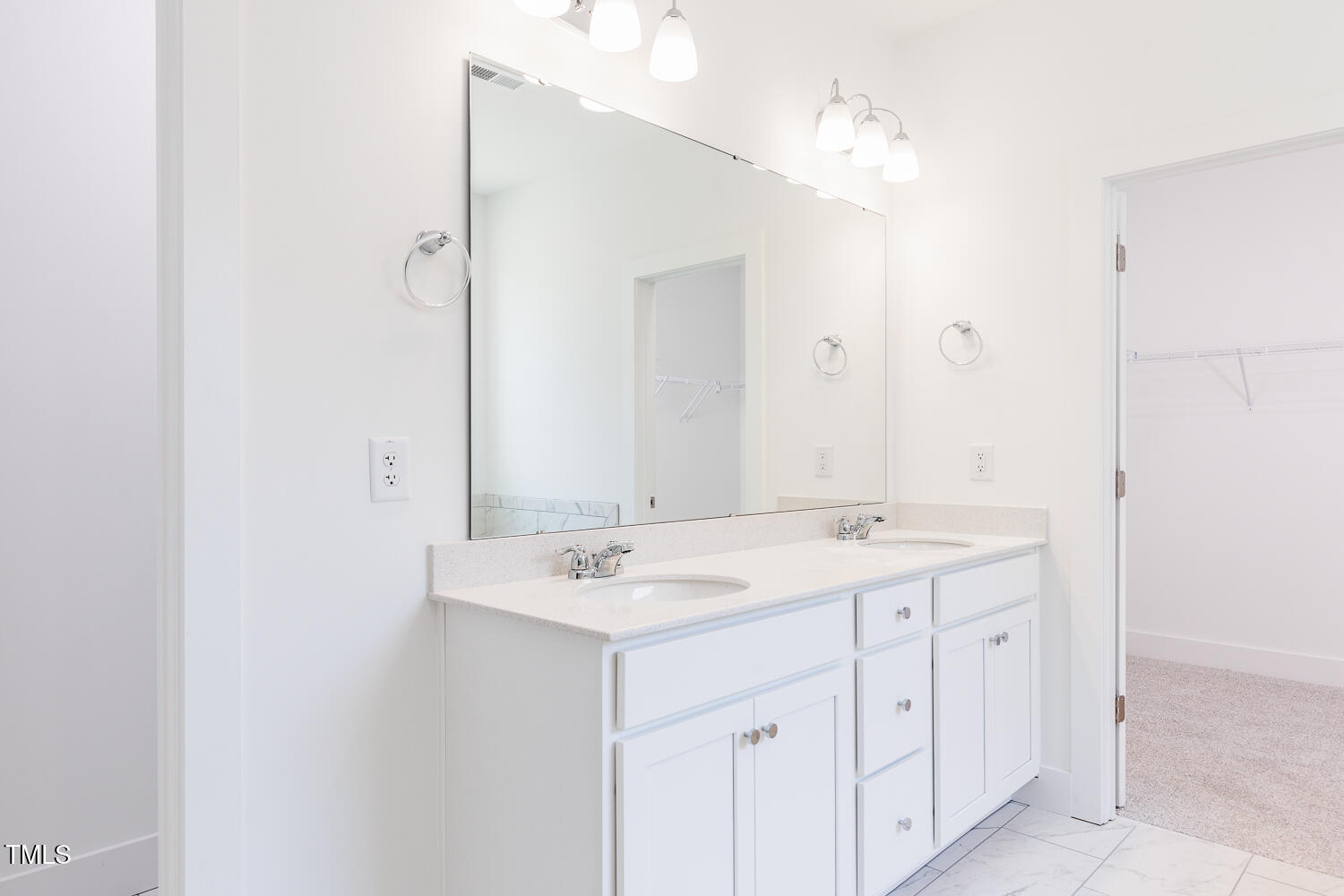63 Tee Time Terrace Four Oaks, NC 27524 - Photo 22 of 36 a bathroom with a sink a mirror and a vanity