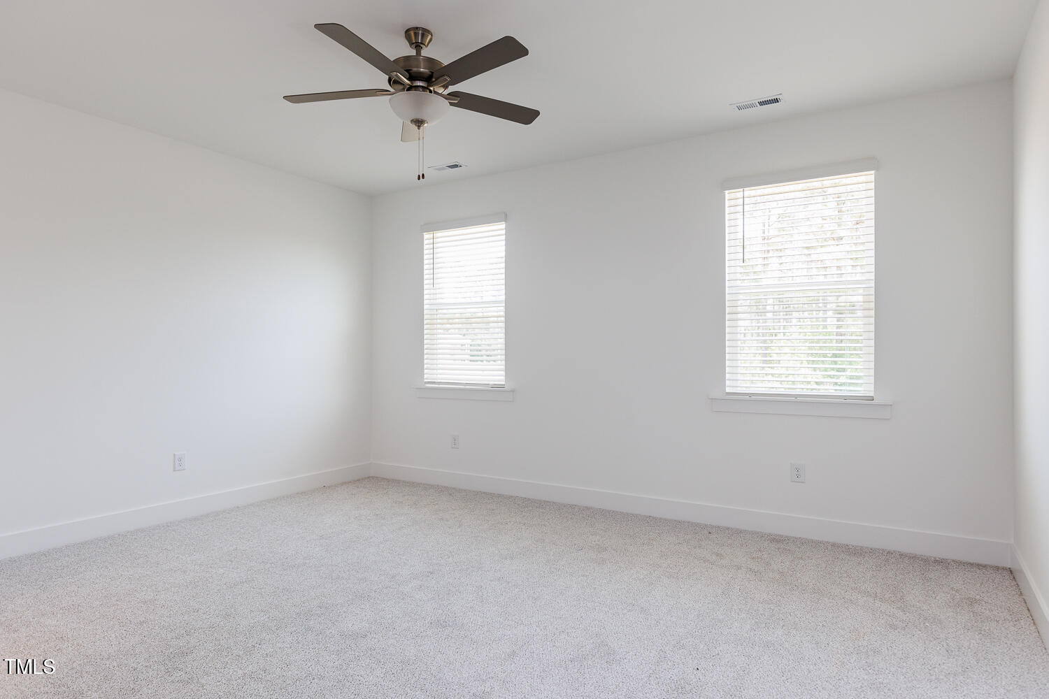 63 Tee Time Terrace Four Oaks, NC 27524 - Photo 27 of 36 an empty room with a window and a fan