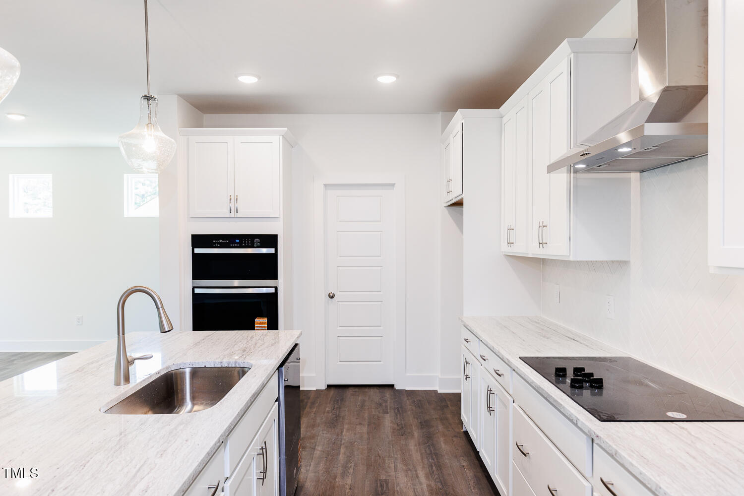 63 Tee Time Terrace Four Oaks, NC 27524 - Photo 5 of 36 a kitchen with kitchen island a sink a stove and cabinets