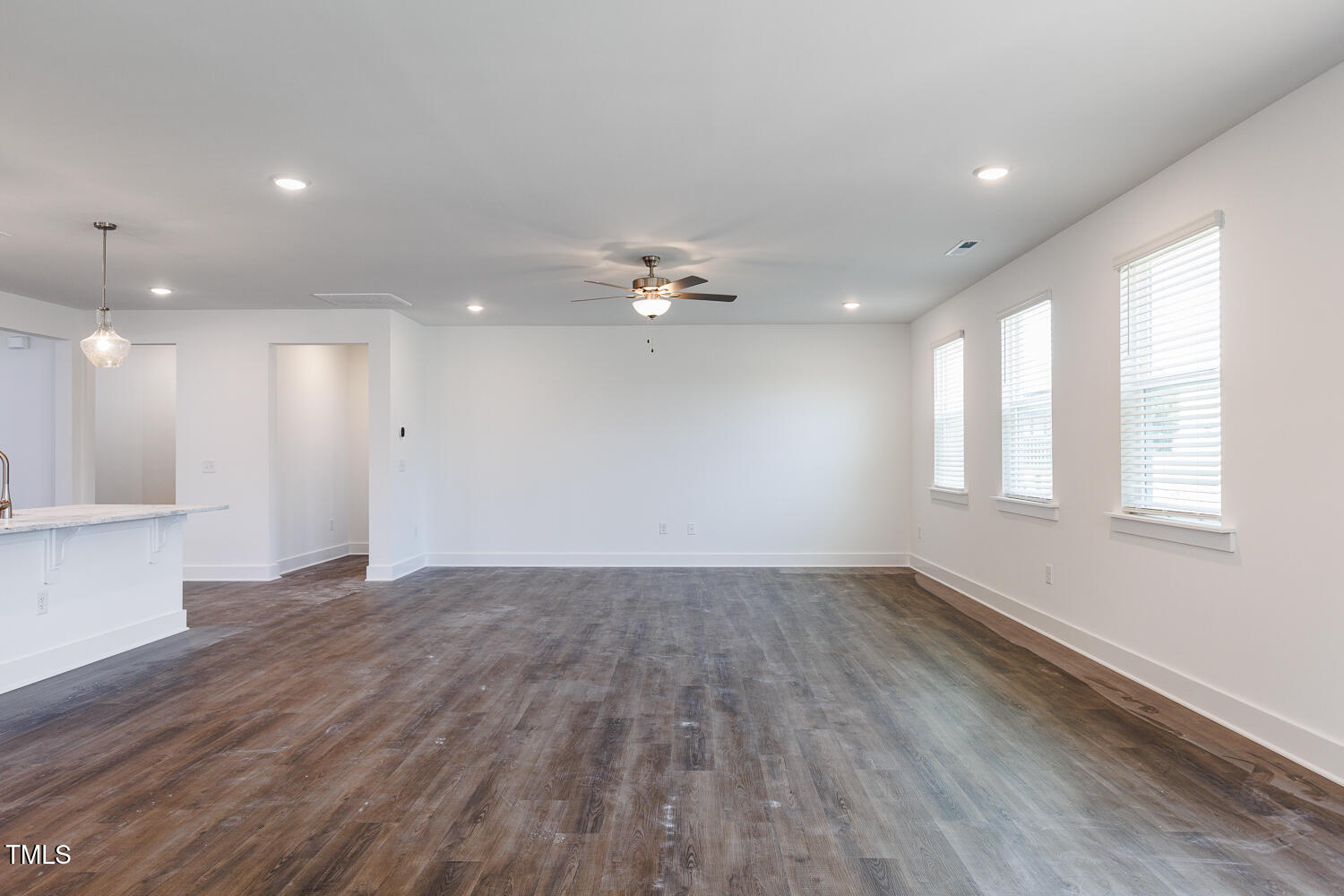 63 Tee Time Terrace Four Oaks, NC 27524 - Photo 8 of 36 a view of an empty room with wooden floor and a window