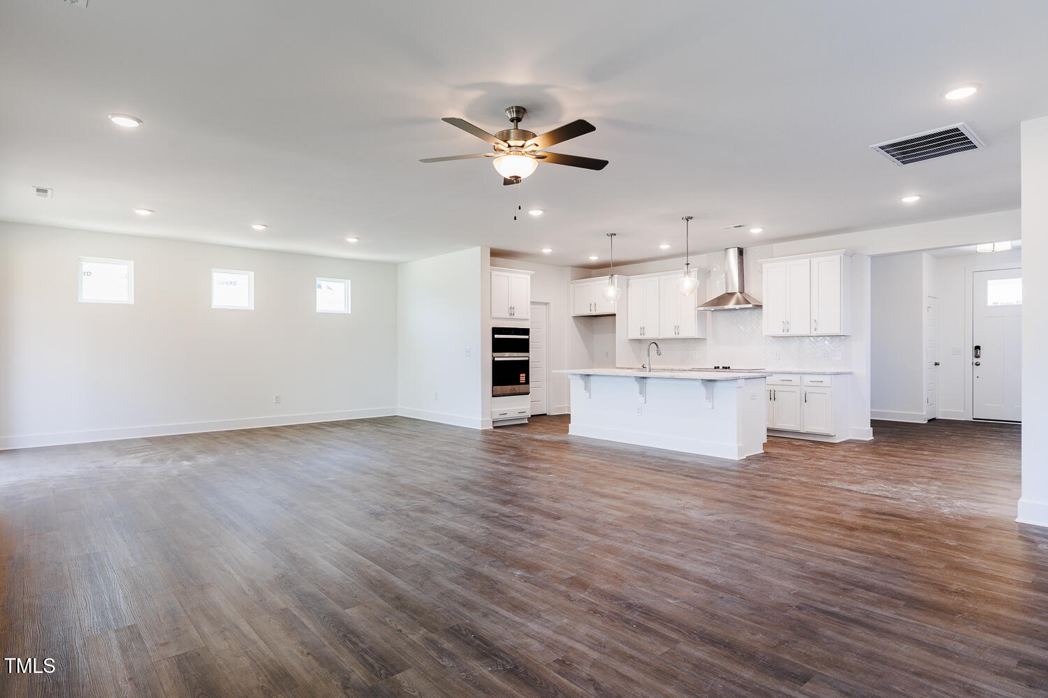 63 Tee Time Terrace Four Oaks, NC 27524 - Photo 9 of 36 a view of an empty room with kitchen and kitchen appliances
