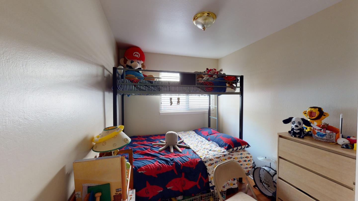 2408 Palmetto Avenue Pacifica, CA 94044 - Photo 11 of 51 a bedroom with a bed and cabinets