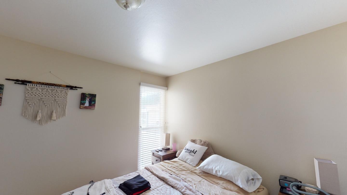 2408 Palmetto Avenue Pacifica, CA 94044 - Photo 12 of 51 a bedroom with a bed and wooden floor