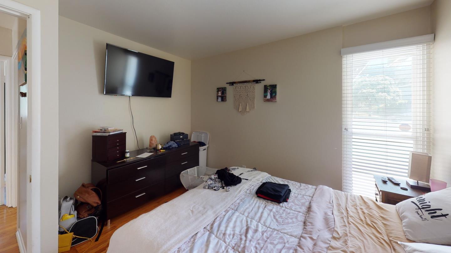 2408 Palmetto Avenue Pacifica, CA 94044 - Photo 14 of 51 a bedroom with a bed and a flat tv screen on the dresser