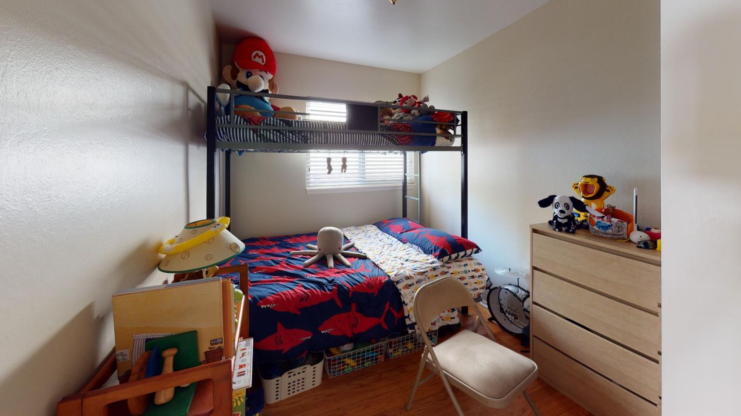 2408 Palmetto Avenue Pacifica, CA 94044 - Photo 16 of 51 a bedroom with a bed and cabinets