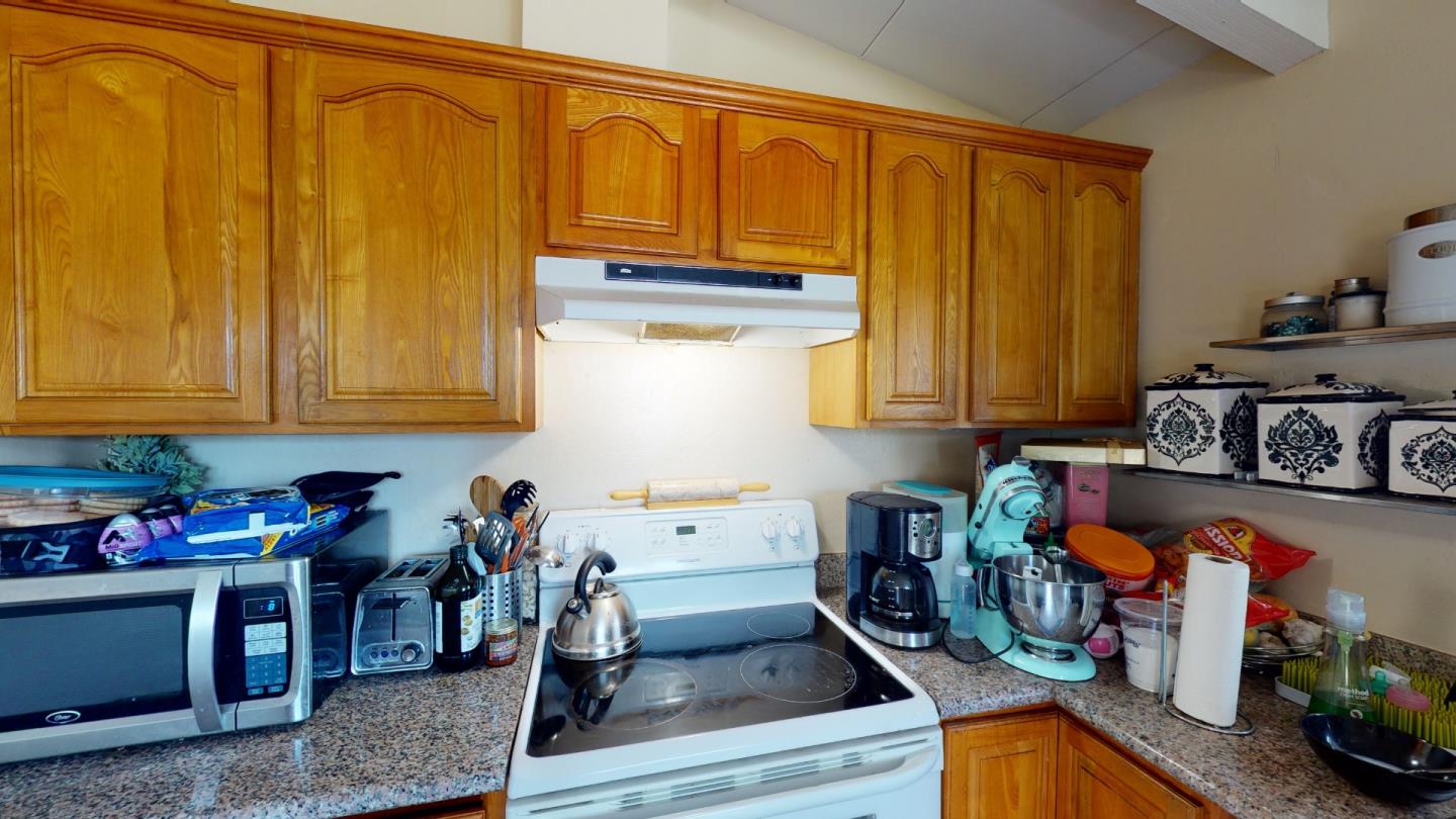 2408 Palmetto Avenue Pacifica, CA 94044 - Photo 26 of 51 a kitchen with stainless steel appliances granite countertop a refrigerator and a stove top oven