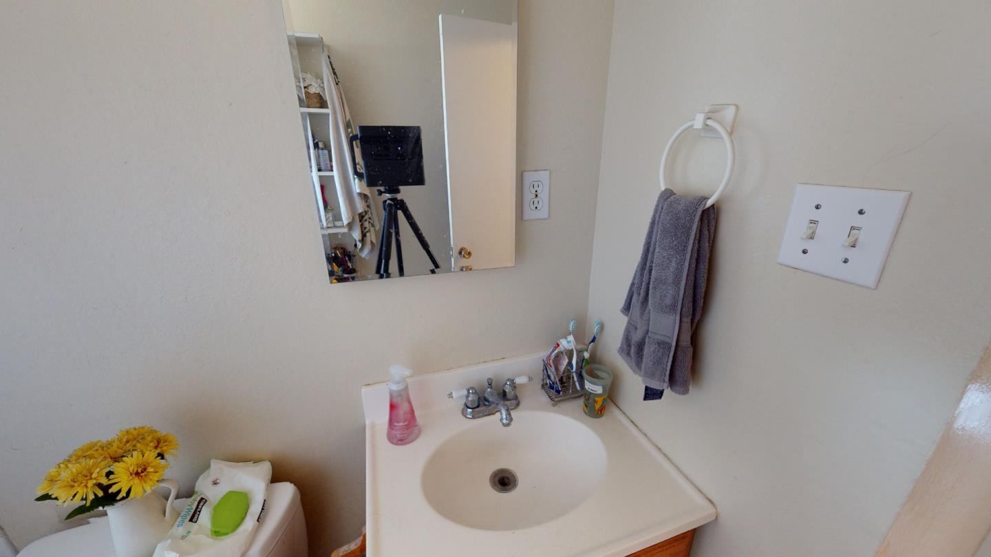 2408 Palmetto Avenue Pacifica, CA 94044 - Photo 28 of 51 a bathroom with a sink mirror and vanity