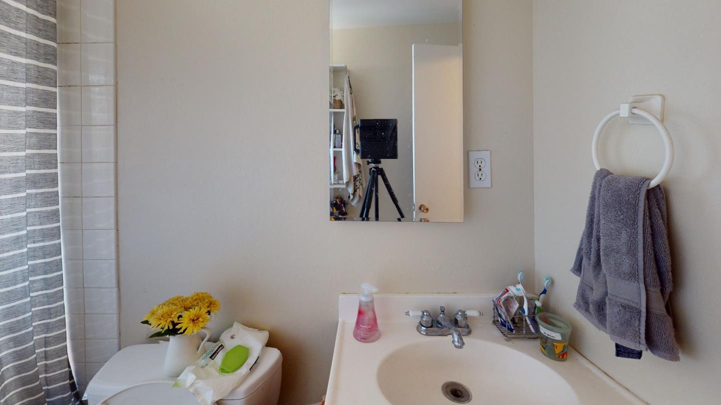 2408 Palmetto Avenue Pacifica, CA 94044 - Photo 30 of 51 a bathroom with a sink and a mirror