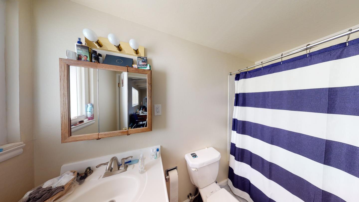 2408 Palmetto Avenue Pacifica, CA 94044 - Photo 39 of 51 a bathroom with a sink and a mirror