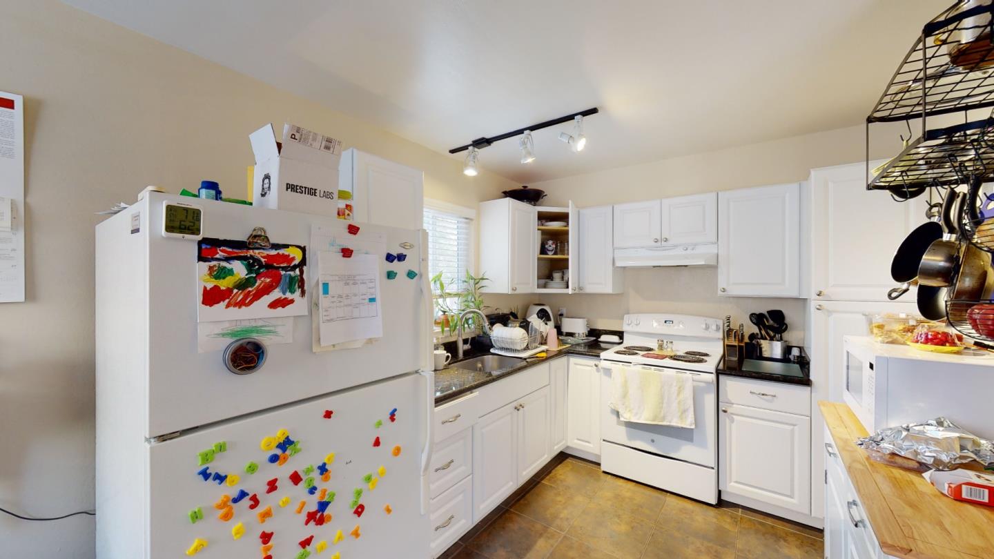 2408 Palmetto Avenue Pacifica, CA 94044 - Photo 5 of 51 a white kitchen with stainless steel appliances a stove a sink and white cabinets