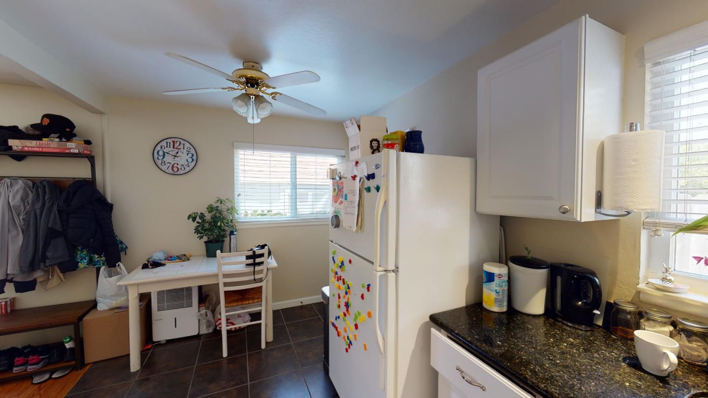 2408 Palmetto Avenue Pacifica, CA 94044 - Photo 6 of 51 a kitchen with granite countertop a refrigerator a stove a sink a dining table and chairs with wooden floor