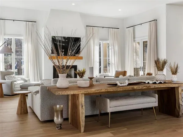 a kitchen with stainless steel appliances granite countertop a sink a stove a table and chairs