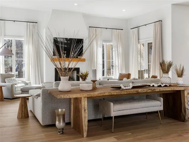 a kitchen with stainless steel appliances granite countertop a sink a stove a table and chairs