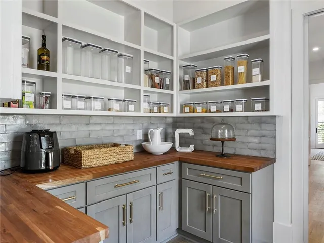 a bathroom with double vanity sinks a vanity a lamp and a mirror