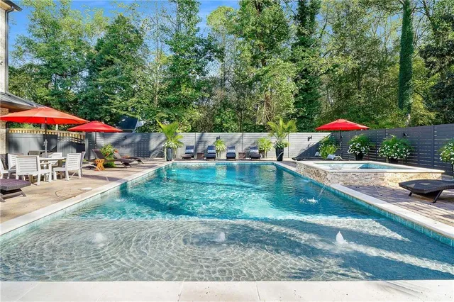 a view of a backyard with a patio and fire pit